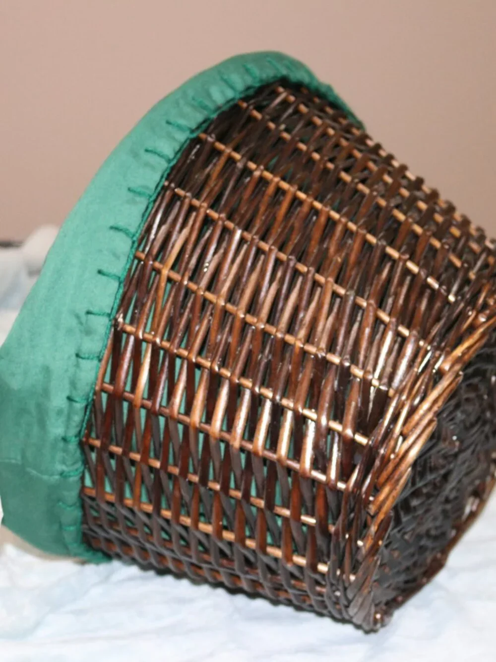 Dark brown circular handle basket with lining.